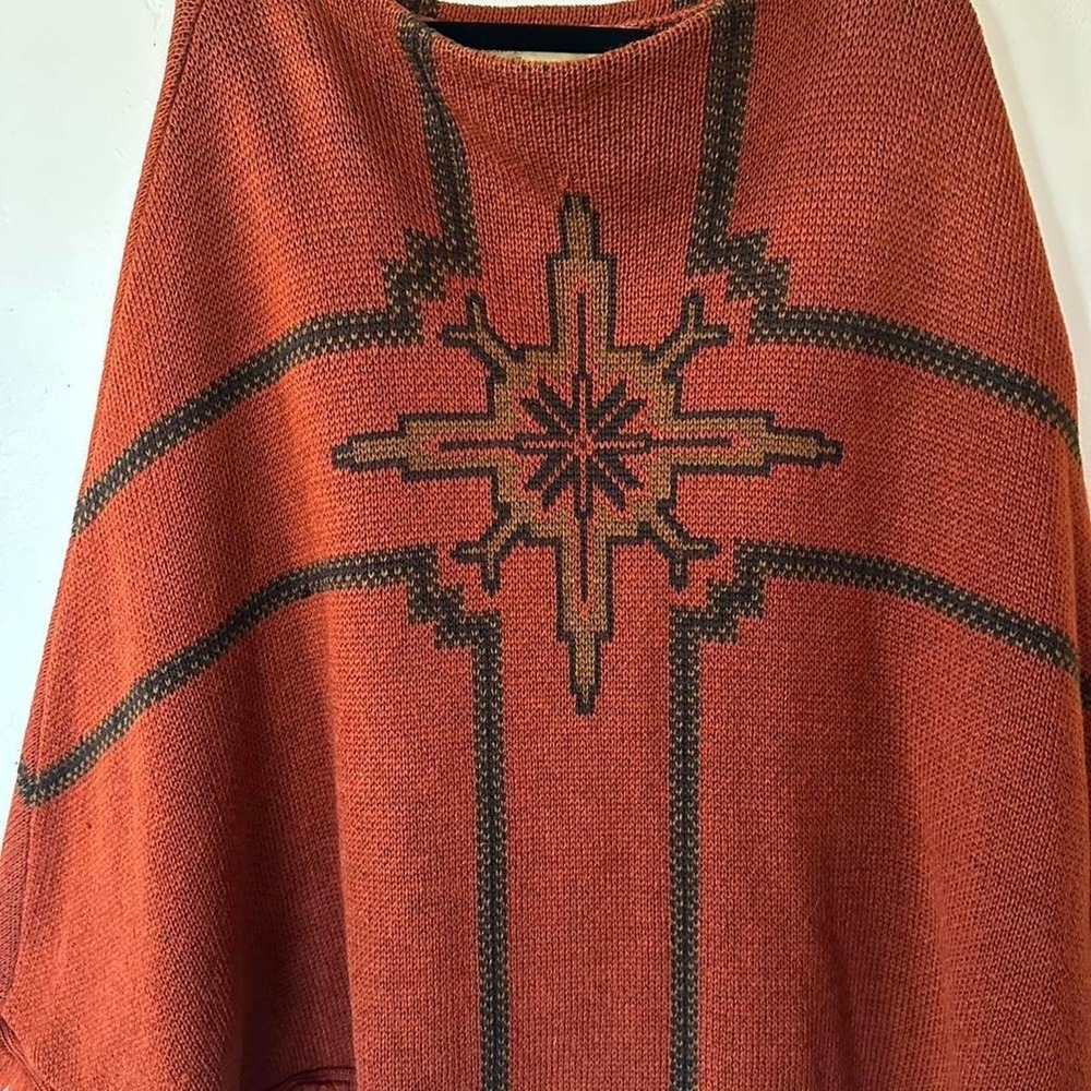 Vintage 70s‎ virgin wool poncho with black geometric starburst design on orange